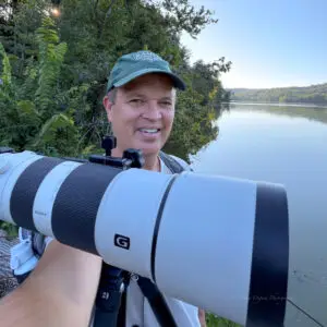 Wildlife photographer Jeremy Osgood with camera and tripod at Radnor Lake State Park, Tennessee